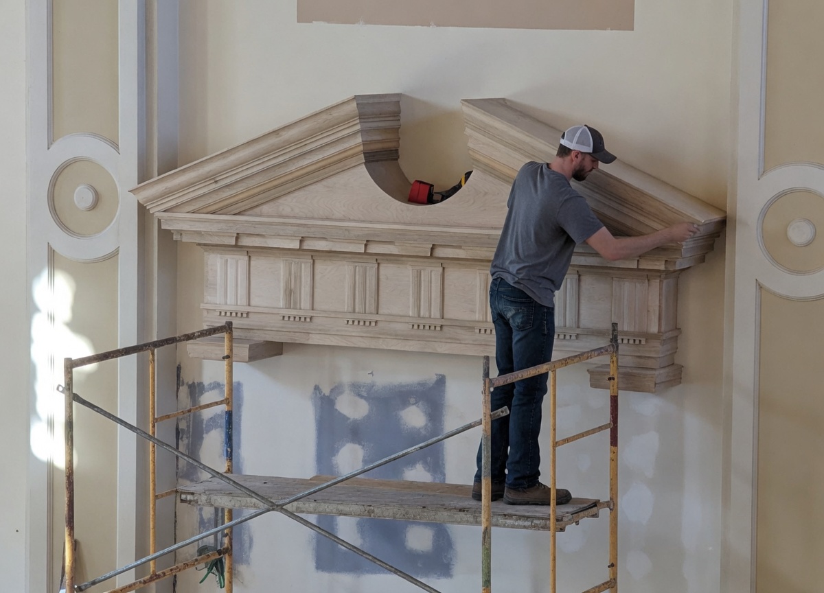 Craftsman installing pediment on scaffolding — Mississippi County Courthouse